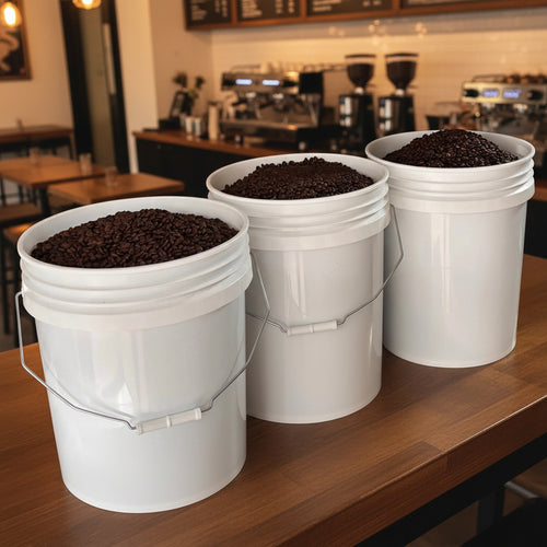 Three white buckets filled with roasted coffee beans